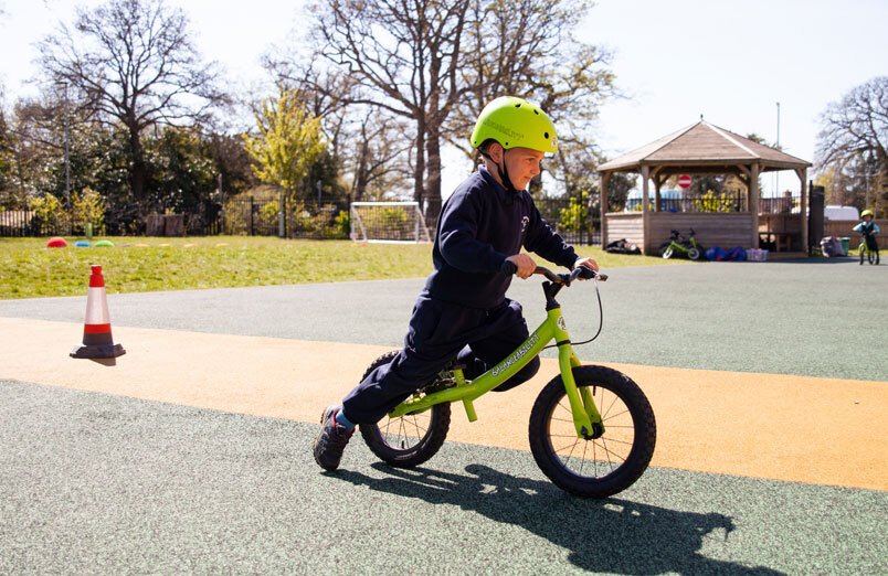 St Margarets School Balanceability Workshop boy on balance bike riding in Junior School playground